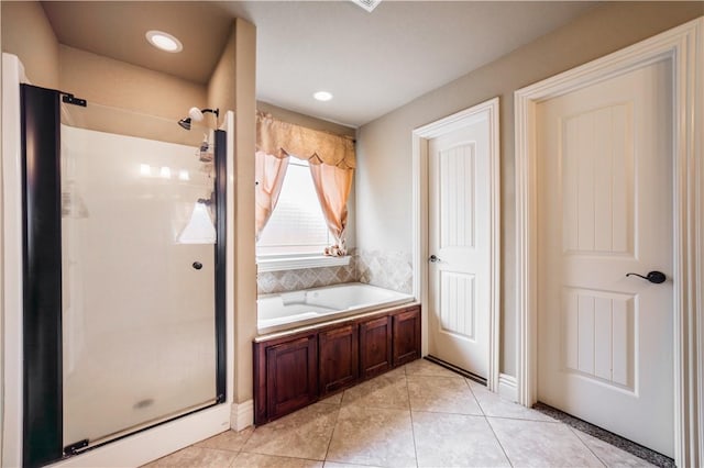 bathroom with a garden tub, tile patterned floors, and a stall shower