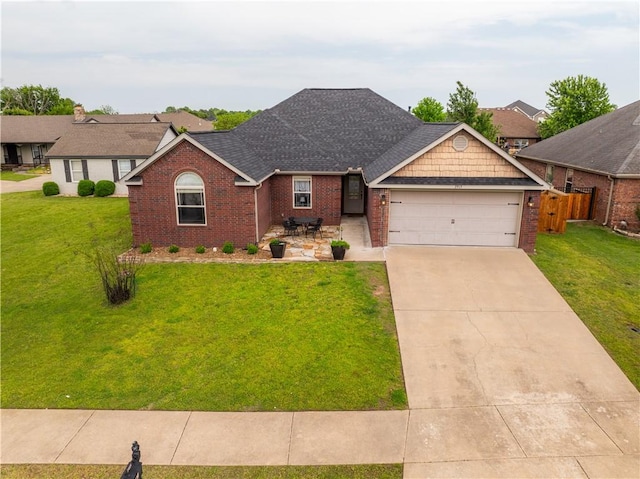 ranch-style house with a garage, a front yard, roof with shingles, brick siding, and driveway