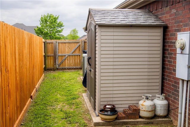 view of outbuilding featuring a gate and fence
