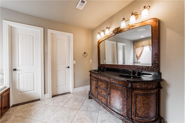 2915 N 15th Pl, Rogers, AR 72756 - bathroom featuring double vanity, tile patterned flooring, and baseboards