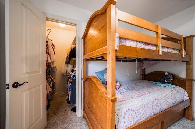 carpeted bedroom featuring a closet and a spacious closet