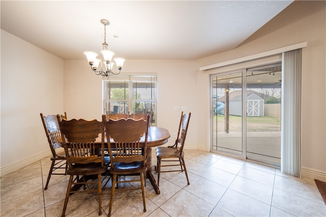 dining room with an inviting chandelier, baseboards, and light tile patterned floors
