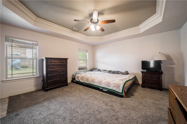 carpeted bedroom with visible vents, ornamental molding, a raised ceiling, and baseboards