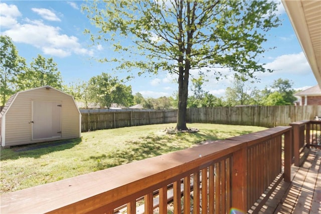 exterior space with a yard, an outdoor structure, a fenced backyard, and a shed
