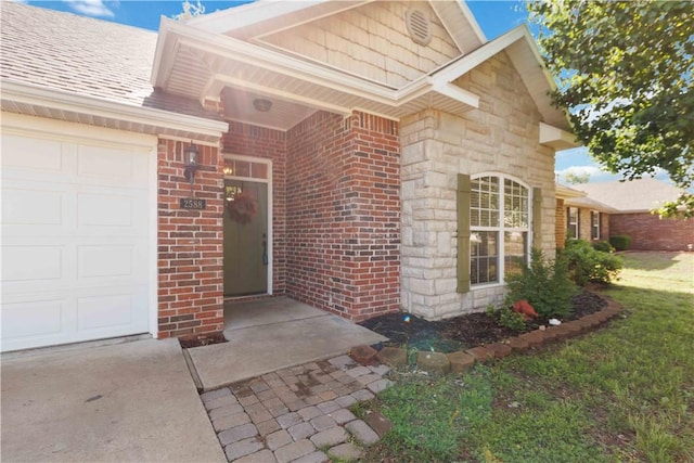 property entrance with an attached garage and brick siding