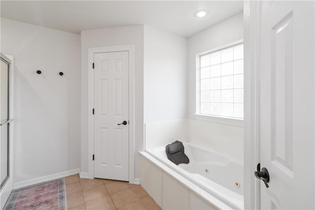 bathroom with an enclosed shower, a whirlpool tub, tile patterned floors, and baseboards