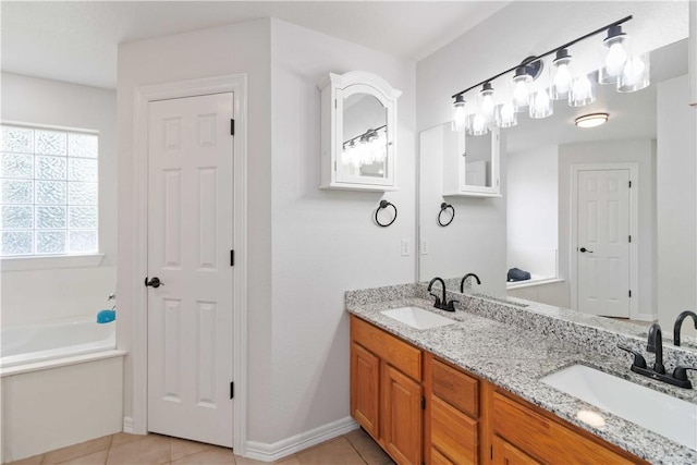 bathroom with a sink, tile patterned flooring, a garden tub, and double vanity