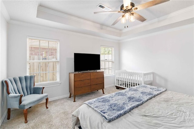 bedroom featuring visible vents, carpet flooring, a raised ceiling, and crown molding