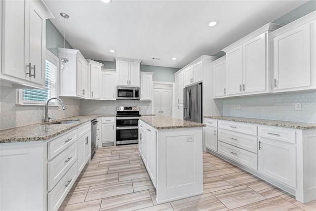kitchen with white cabinetry, appliances with stainless steel finishes, and a sink