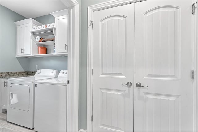 washroom featuring cabinet space and washing machine and clothes dryer