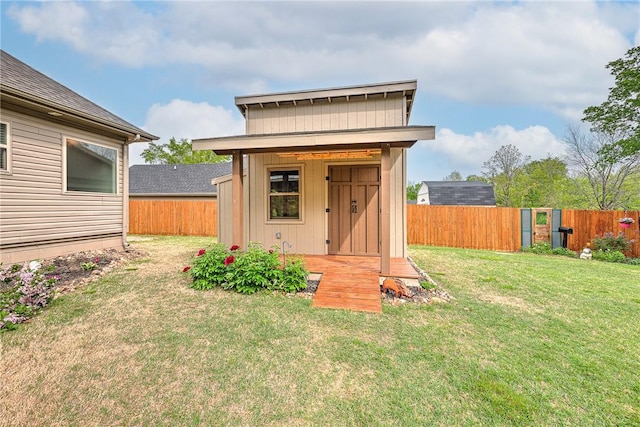 view of outbuilding with a fenced backyard and an outbuilding