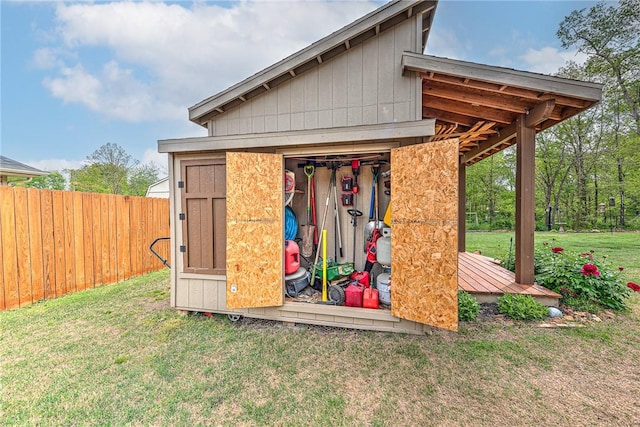 view of outbuilding with fence and an outbuilding
