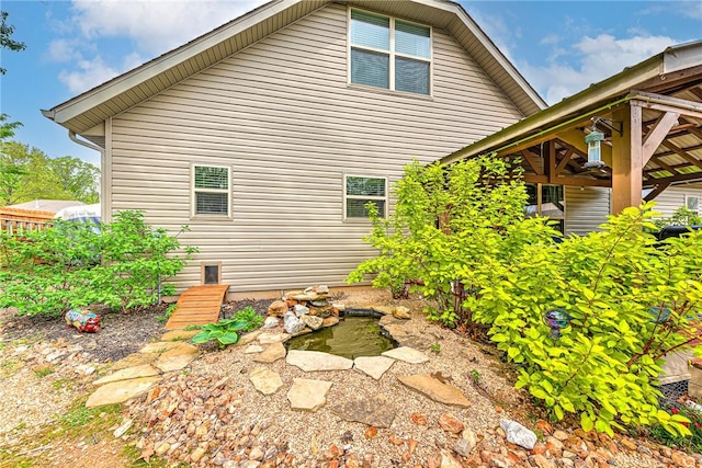 view of property exterior with a small pond