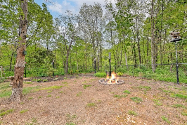 view of yard with a fire pit and a fenced backyard