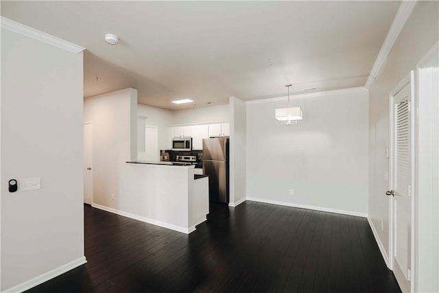 kitchen with white cabinets, baseboards, appliances with stainless steel finishes, and dark wood finished floors