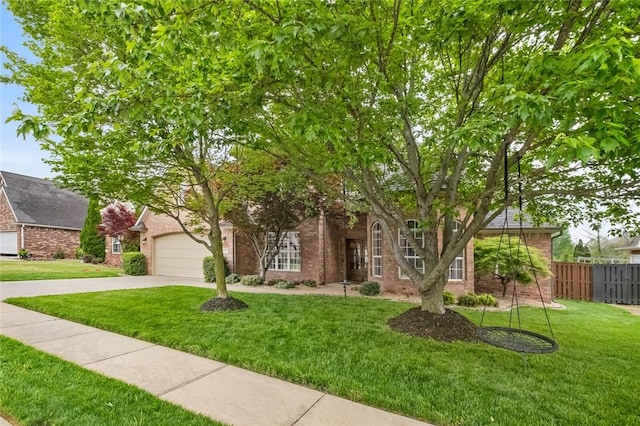obstructed view of property featuring fence, a front lawn, brick siding, a garage, and driveway