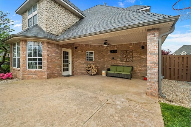 back of property with fence, a ceiling fan, a patio area, and brick siding