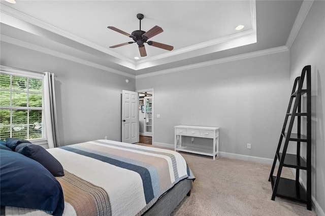 carpeted bedroom with ceiling fan, a raised ceiling, baseboards, ornamental molding, and recessed lighting