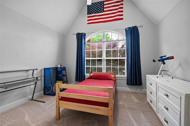 bedroom with baseboards, vaulted ceiling, and light colored carpet