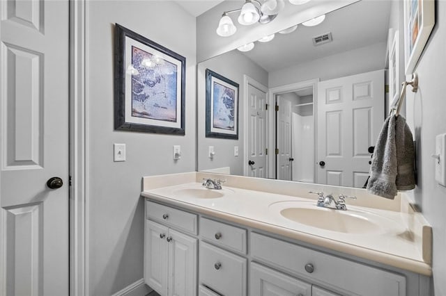 bathroom featuring double vanity, visible vents, and a sink