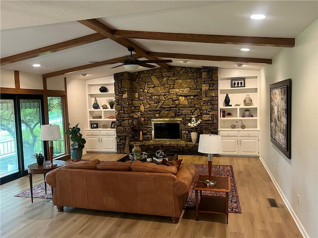 living room with a ceiling fan, visible vents, baseboards, light wood-style floors, and vaulted ceiling with beams