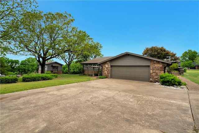 ranch-style home with stone siding, driveway, a front lawn, and a garage