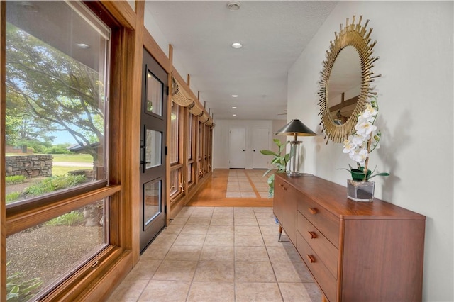 hall with light tile patterned floors and recessed lighting