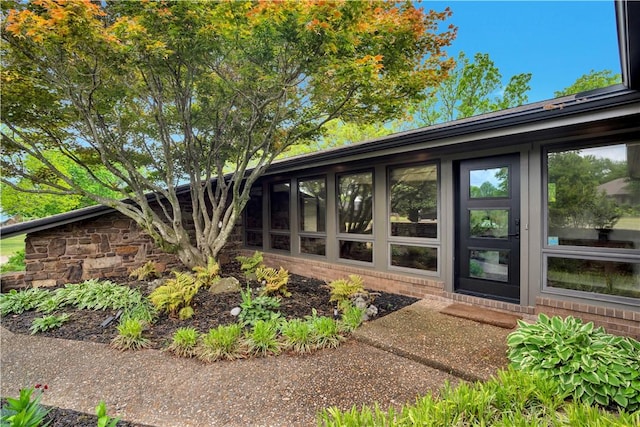 view of property exterior with brick siding