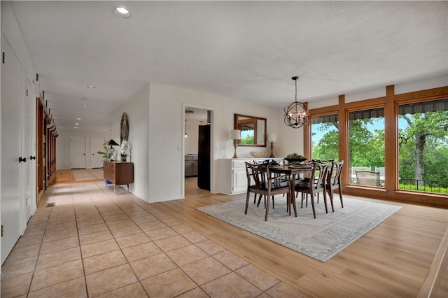 dining area featuring recessed lighting, a notable chandelier, and light wood-style floors