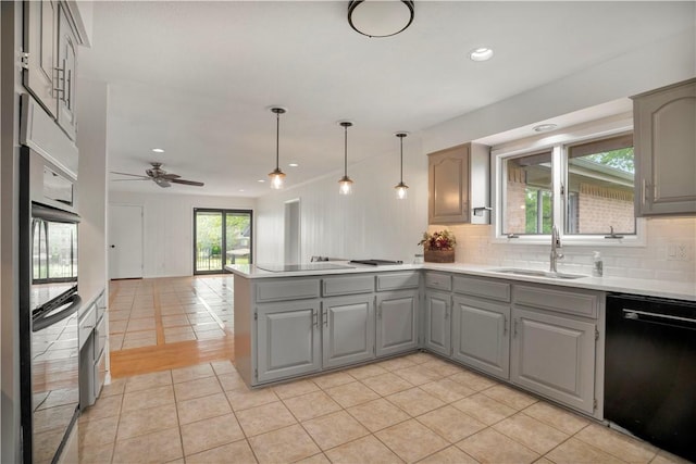 kitchen featuring a sink, a peninsula, gray cabinets, black appliances, and open floor plan