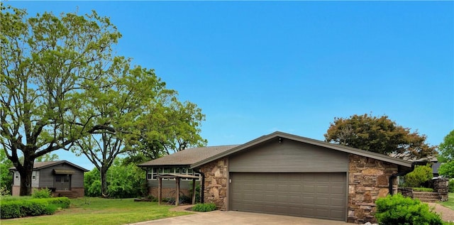 ranch-style house featuring concrete driveway, a garage, stone siding, and a front yard