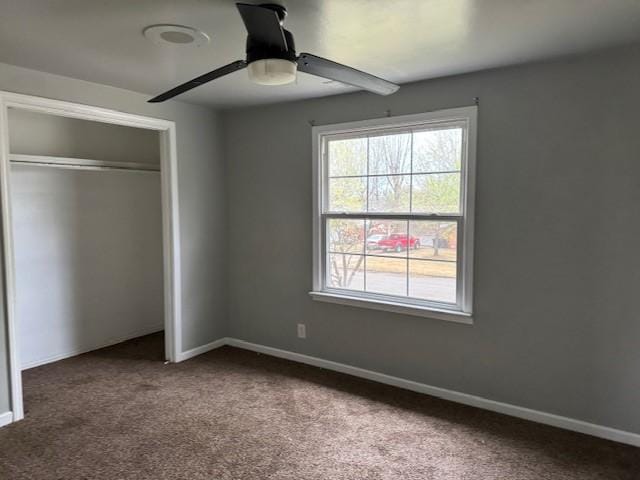 unfurnished bedroom with carpet floors, baseboards, and a closet