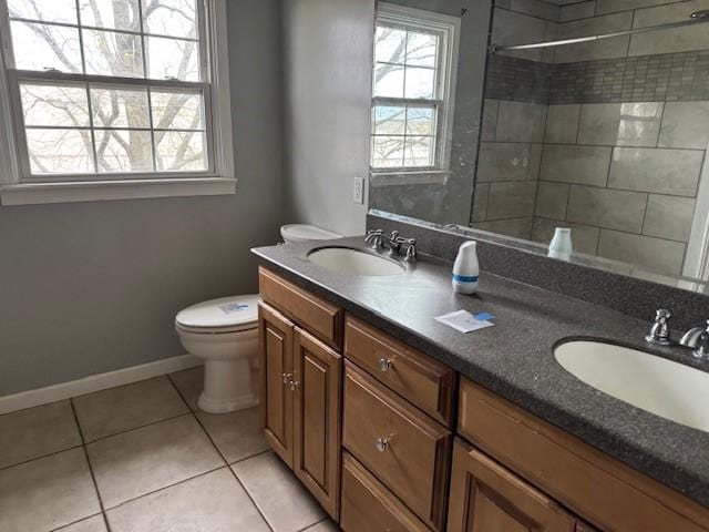 full bath with a sink, tile patterned floors, and a wealth of natural light
