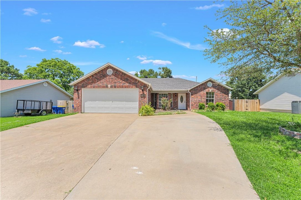 711 Del Cir, Lowell, AR 72745 - ranch-style house with driveway, brick siding, a garage, and central AC