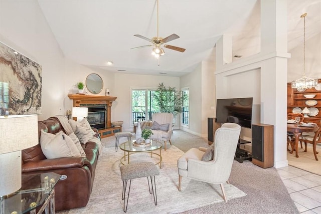2 Breton Ln, Bella Vista, AR 72715 - living area featuring a glass covered fireplace, ceiling fan, light carpet, a chandelier, and lofted ceiling