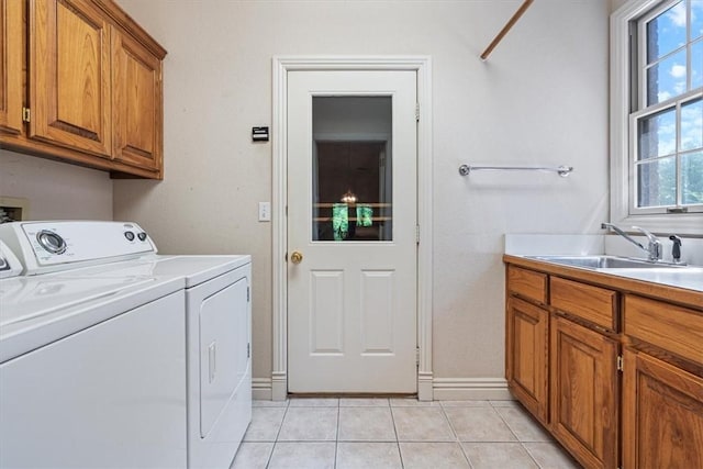2 Breton Ln, Bella Vista, AR 72715 - laundry area featuring washer and dryer, light tile patterned flooring, cabinet space, and baseboards
