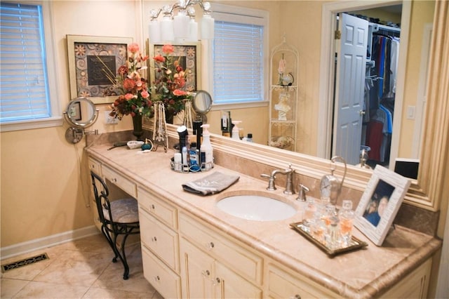 bathroom with visible vents, baseboards, tile patterned floors, and vanity