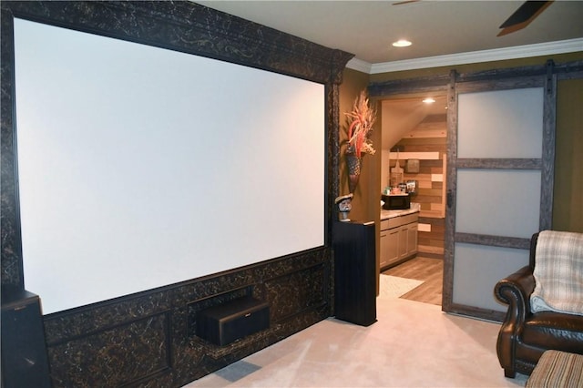 cinema room featuring crown molding, wooden walls, recessed lighting, a barn door, and a ceiling fan