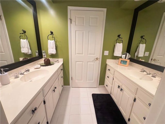 bathroom with two vanities, a sink, and tile patterned flooring