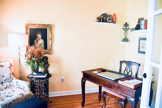 office area with baseboards and wood finished floors