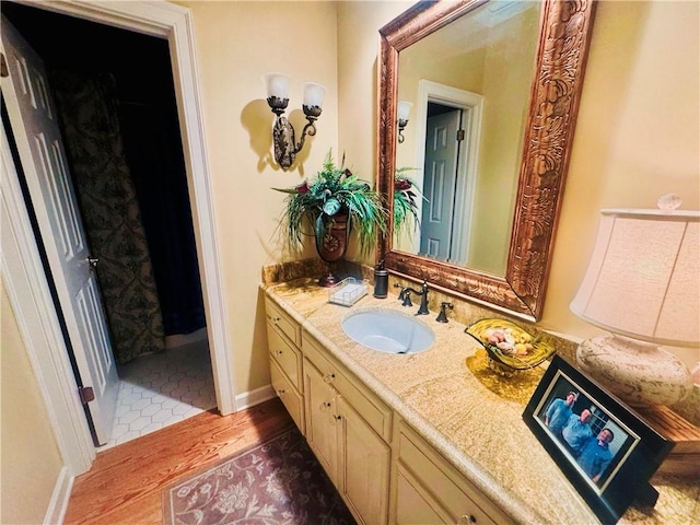 bathroom featuring vanity and wood finished floors
