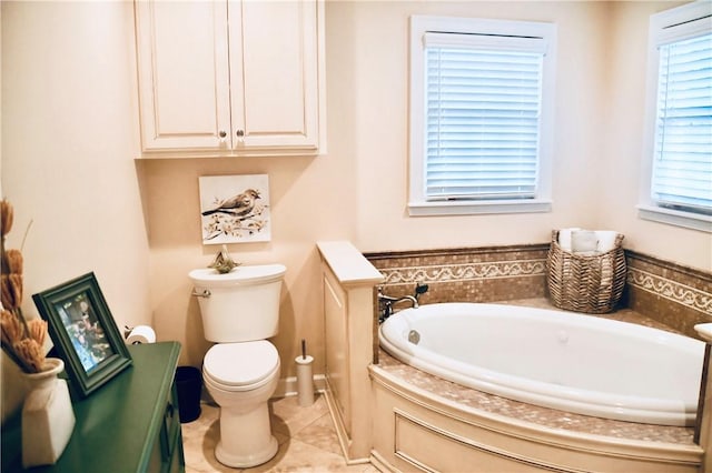 bathroom with toilet, tile patterned floors, and a bath