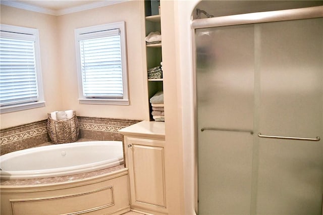 full bath featuring crown molding, a garden tub, and a shower stall