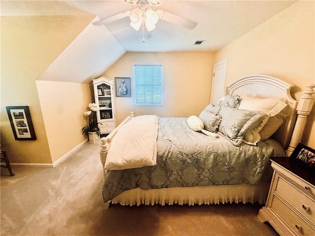carpeted bedroom featuring a ceiling fan, baseboards, visible vents, and lofted ceiling