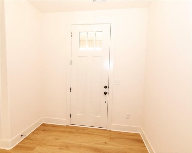 foyer with baseboards and light wood-type flooring