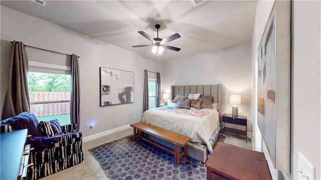 carpeted bedroom with baseboards and a ceiling fan