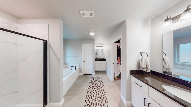 full bath with a sink, a marble finish shower, two vanities, visible vents, and a garden tub