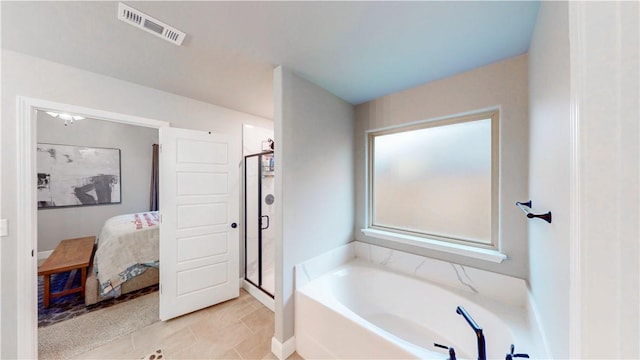ensuite bathroom featuring visible vents, connected bathroom, a garden tub, and a shower stall