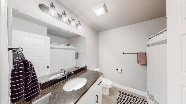 full bath featuring vanity, baseboards, tile patterned flooring, and toilet
