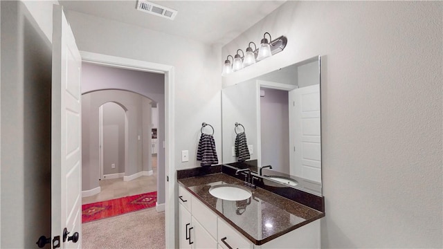 bathroom with visible vents, baseboards, and vanity